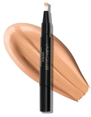 A sleek waterproof eye spackle eye shadow primer by Laura Geller New York positioned beside a smooth swatch of tan colored cream, showcasing its natural finish and ease of application.